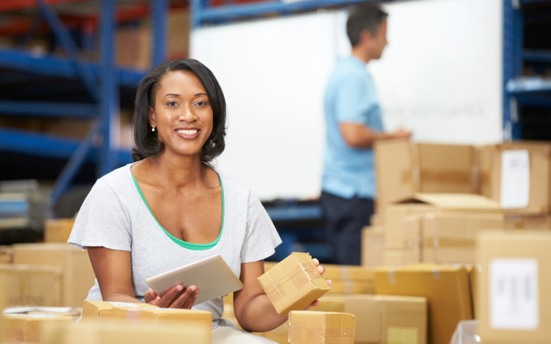 Woman counting inventory of boxes